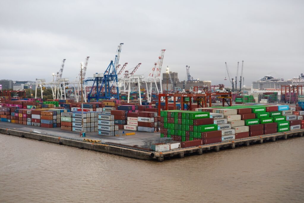 Stacked cargo containers at a shipping port for bulk essential oil import into Malaysia